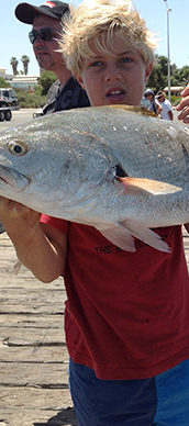 Picture: Young boy with fish on jetty